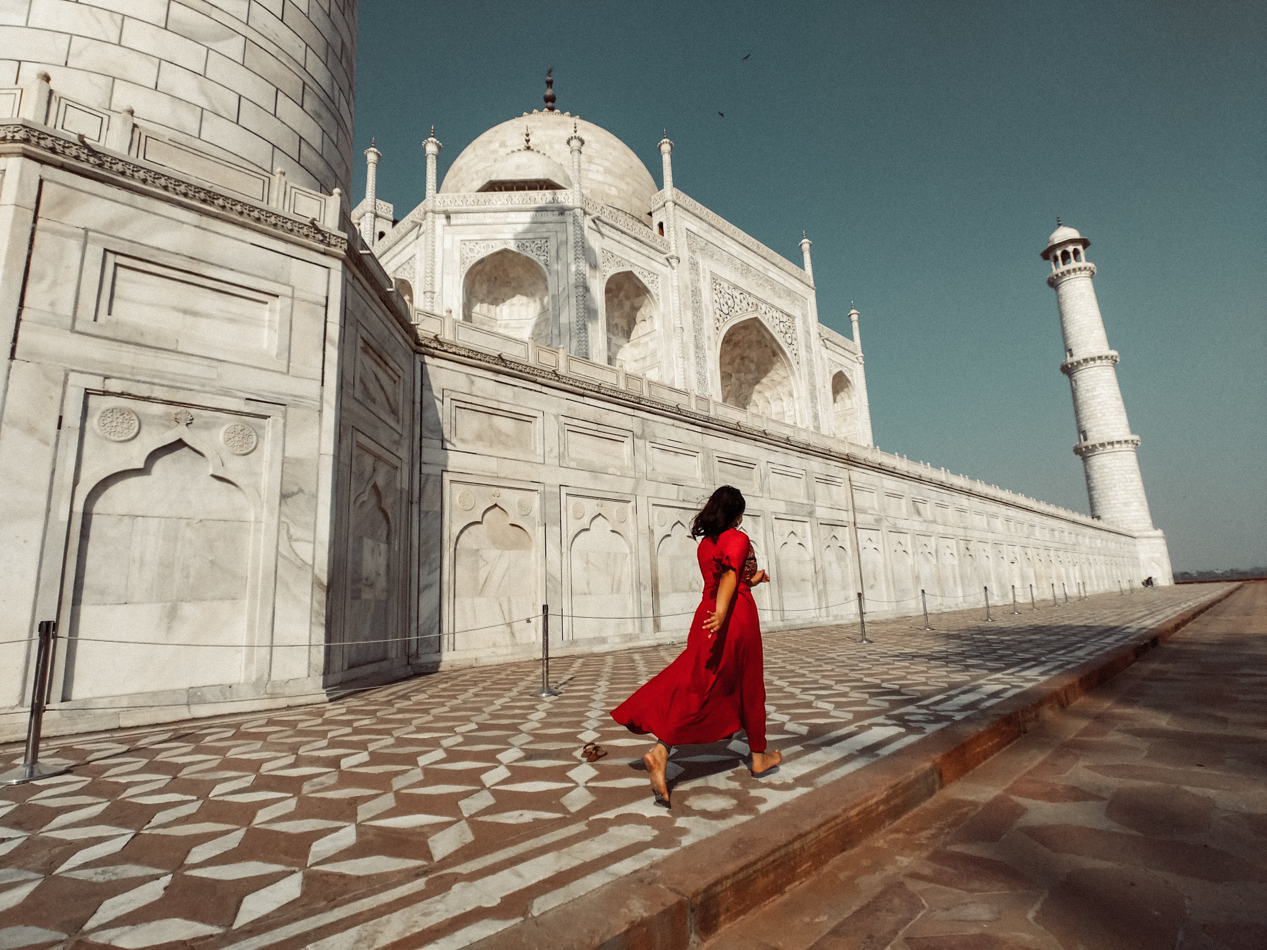 files/a-woman-in-red-passes-the-taj-mahal.jpg