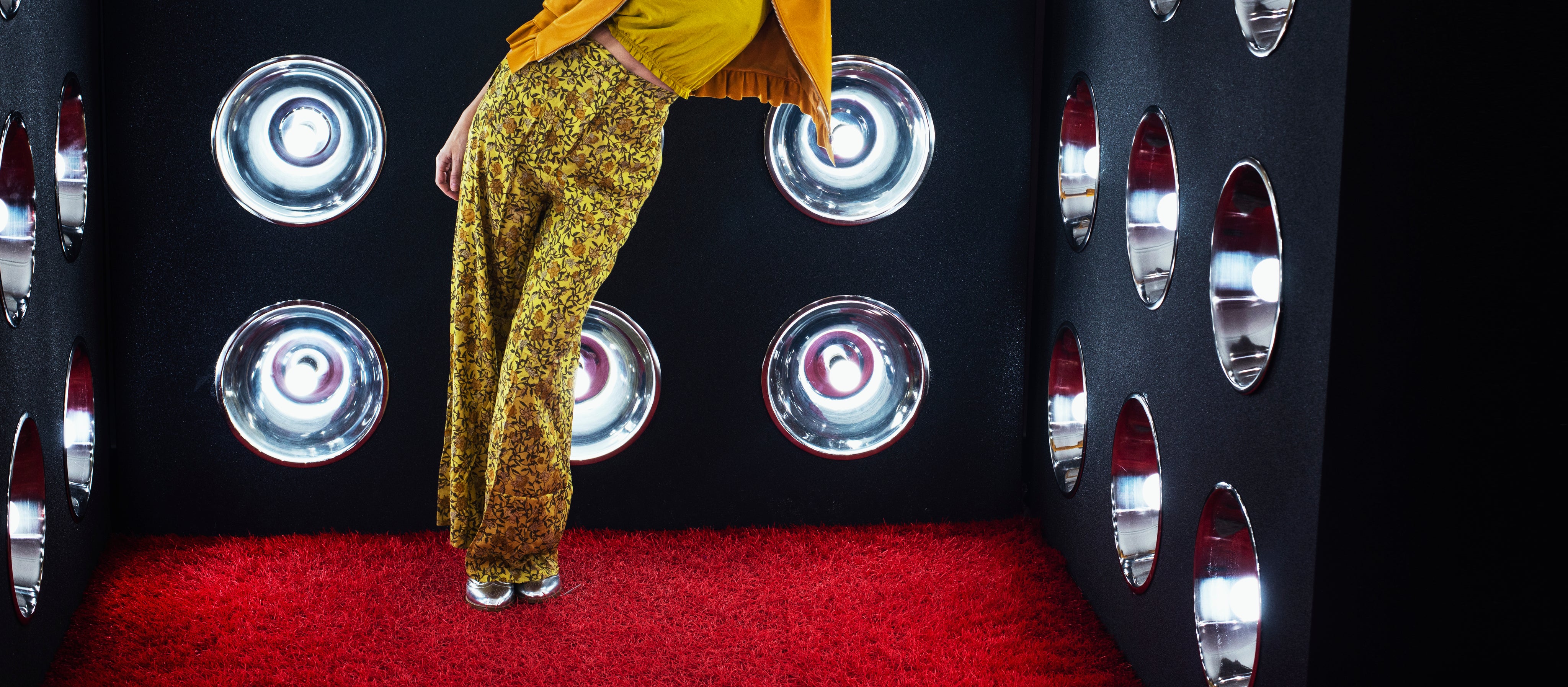files/model-leaning-against-a-wall-of-lights-atop-red-shag-carpet.jpg